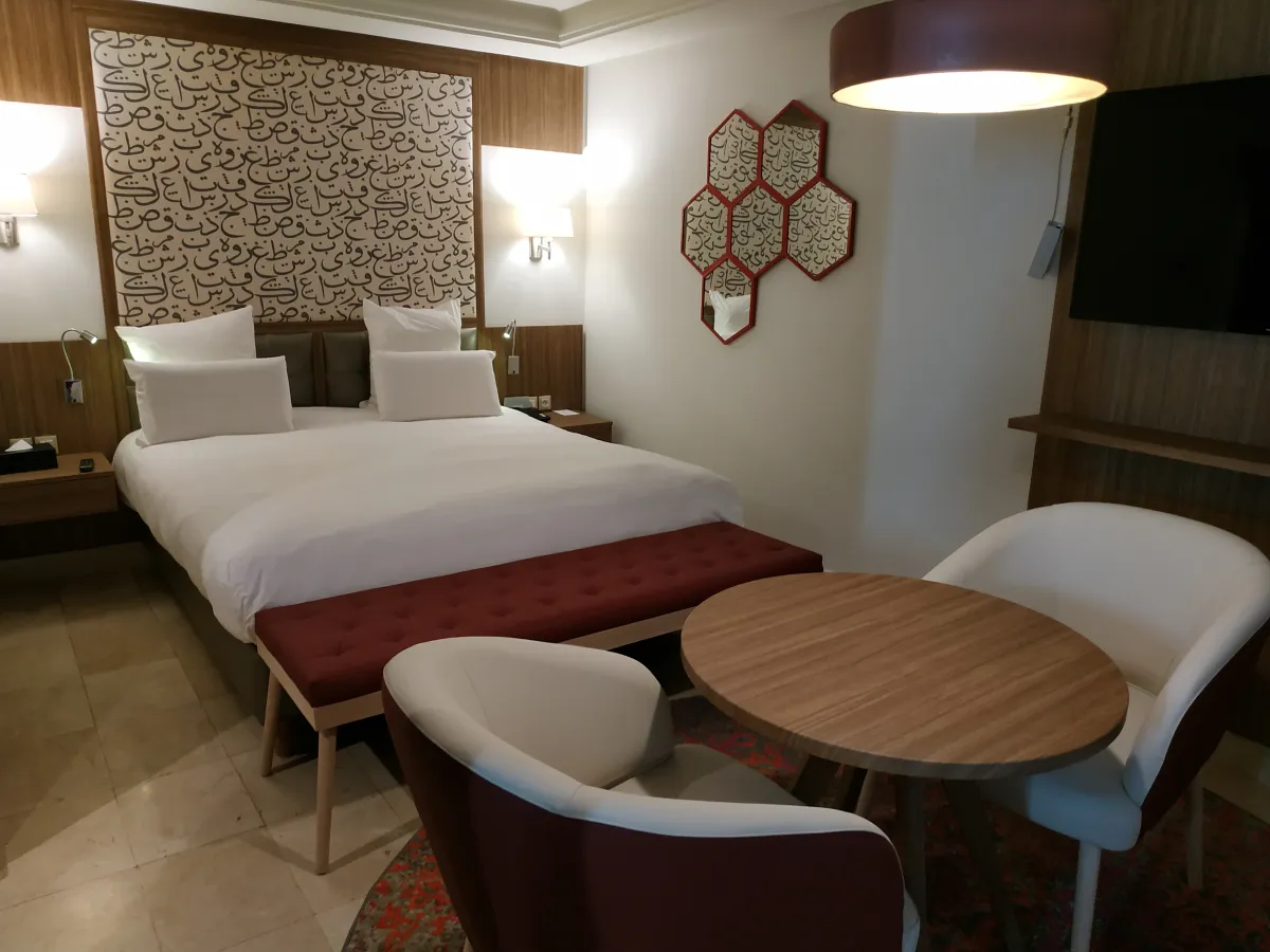 Habitación del Barceló Marrakech con espejos hexagonales, mesa y butacas